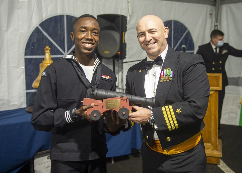 Logistics Specialist 3rd Class Jason Petitfrere (left) assigned to USS Constitution, is awarded Junior Sailor of the Year by the 76th commanding officer of USS Constitution, Cmdr. John A. Benda (right)