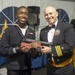 Logistics Specialist 3rd Class Jason Petitfrere (left) assigned to USS Constitution, is awarded Junior Sailor of the Year by the 76th commanding officer of USS Constitution, Cmdr. John A. Benda (right)