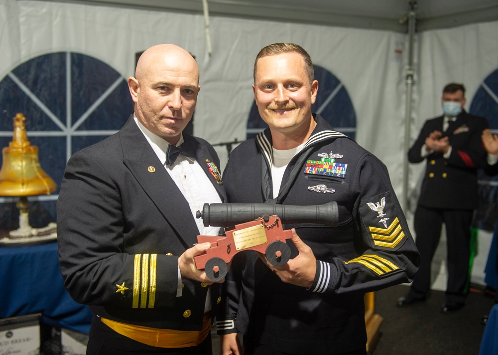 Hospital Corpsman 1st Class Eric Garneau, (right) assigned to USS Constitution, is awarded Senior Sailor of the Year by the 76th commanding officer of USS Constitution, Cmdr. John A. Benda (left)