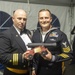 Hospital Corpsman 1st Class Eric Garneau, (right) assigned to USS Constitution, is awarded Senior Sailor of the Year by the 76th commanding officer of USS Constitution, Cmdr. John A. Benda (left)
