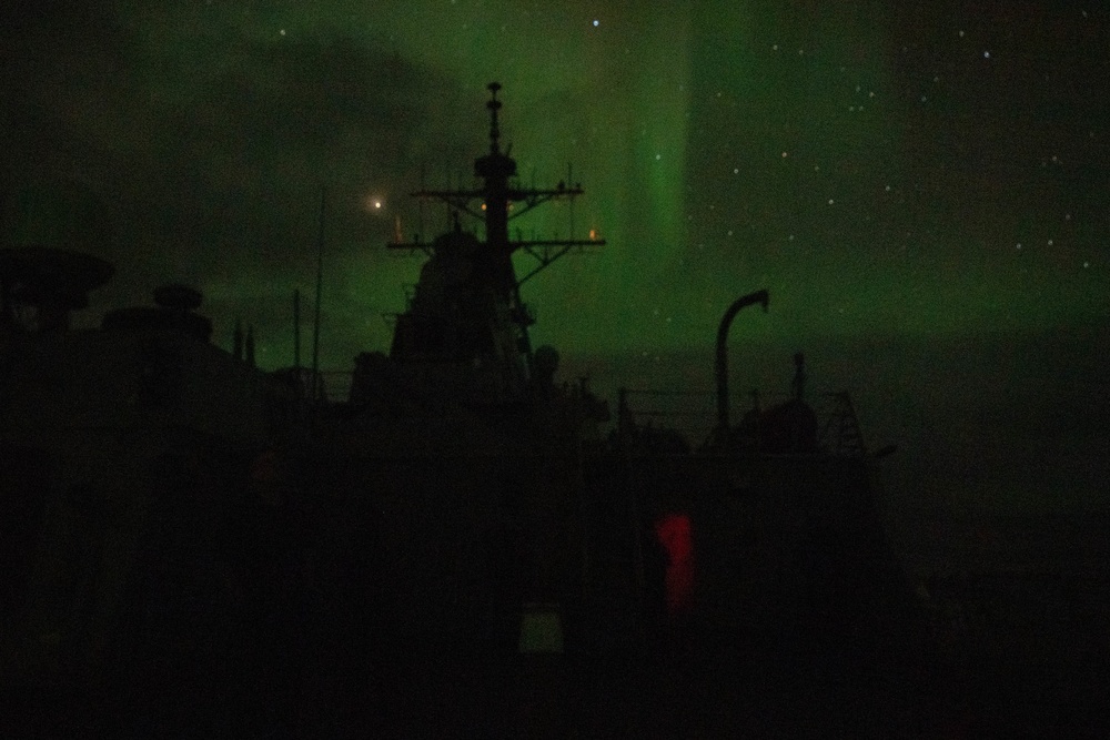 USS Ross (DDG 71) under the Aurora Borealis.
