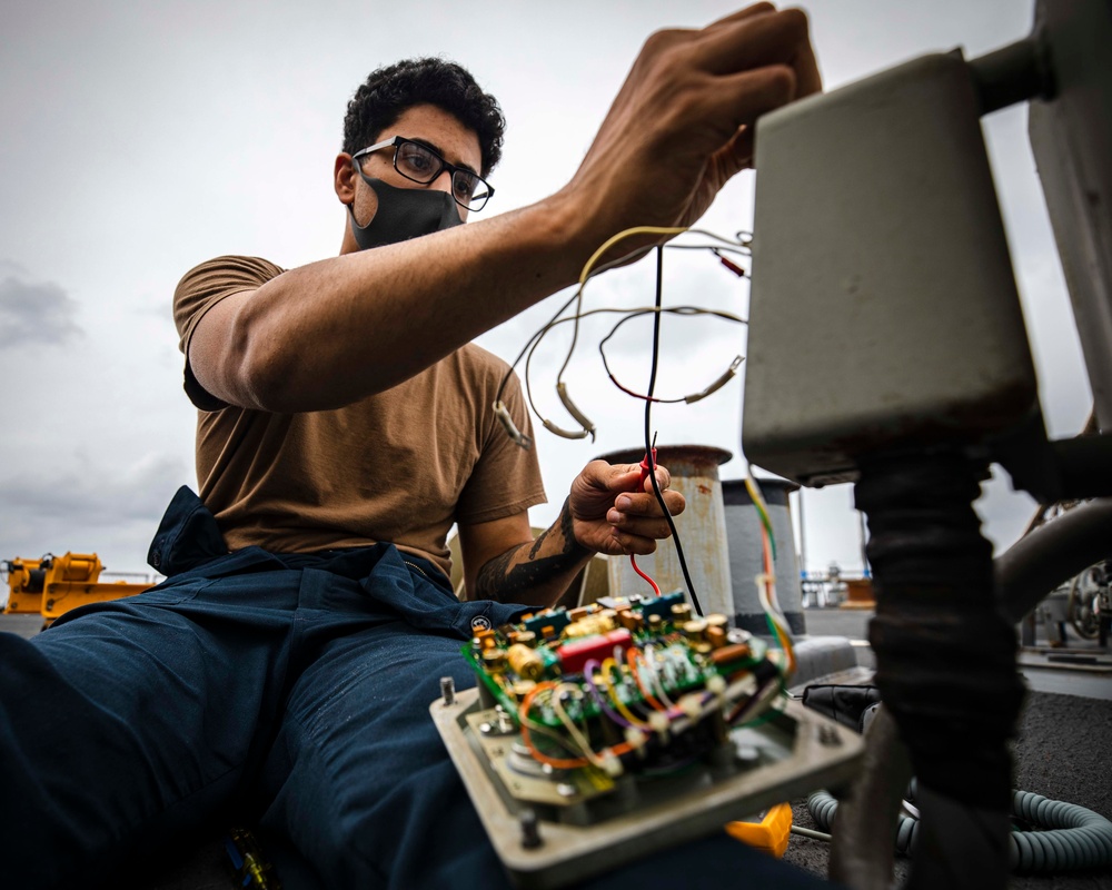 Sailors conduct daily maintenance aboard McCain