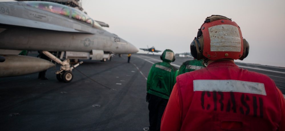 Sailors Observe F/A-18E Super Hornet Landing on Flight Deck