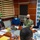 A formal meeting is taking place in what appears to be a Djiboutian government office, specifically the 'Ministère du Travail' (Ministry of Labor), as indicated by the repeated logos on the backdrop. A U.S. Navy officer in camouflage uniform is speaking alongside a civilian woman, facing Djiboutian officials across a conference table. All participants are wearing face masks, suggesting this meeting occurred during the COVID-19 pandemic period.