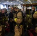 U.S. Navy Sailors put on fire-fighting ensembles during an in-port emergency drill in the hangar bay aboard the aircraft carrier USS John C. Stennis (CVN 74) in Norfolk, Virginia, Oct. 24, 2020.