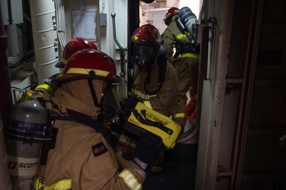 U.S. Navy Sailors prepare to fight a simulated fire during an in-port emergency drill in the hangar bay aboard the aircraft carrier USS John C. Stennis (CVN 74) in Norfolk, Virginia, Oct. 24, 2020.