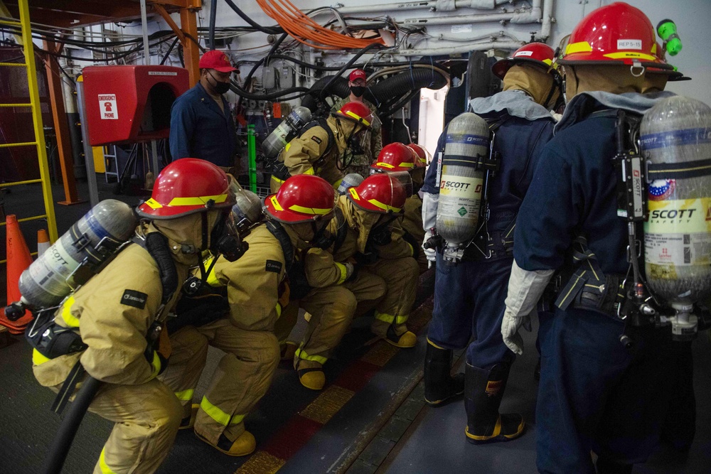 U.S. Navy Sailors fight a simulated fire during an in-port emergency drill in the hangar bay aboard the aircraft carrier USS John C. Stennis (CVN 74) in Norfolk, Virginia, Oct. 24, 2020.