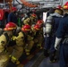 U.S. Navy Sailors fight a simulated fire during an in-port emergency drill in the hangar bay aboard the aircraft carrier USS John C. Stennis (CVN 74) in Norfolk, Virginia, Oct. 24, 2020.