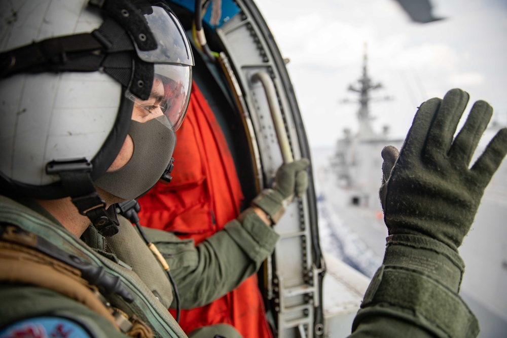 Naval Air Crewman Waves to Crew of Fuyuzuki