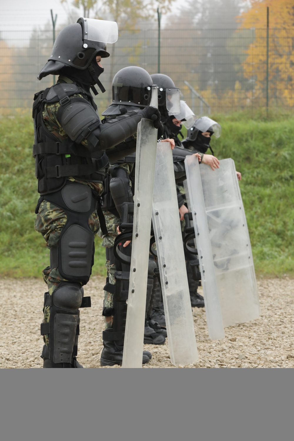 Albanian soldiers stand ready for crowd control training