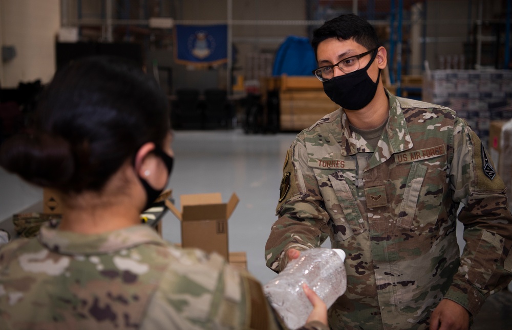 50th Contracting Squadron gives out hand sanitizer
