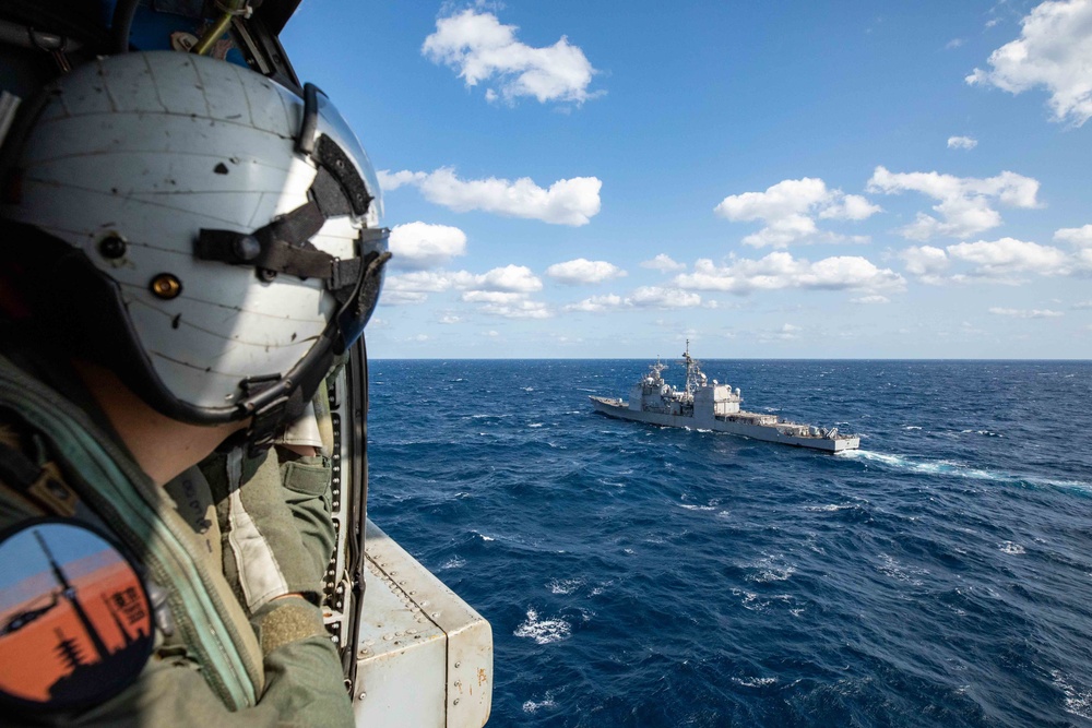 Naval Air Crewman Investigates Flight Deck During Keen Sword 21