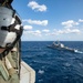 Naval Air Crewman Investigates Flight Deck During Keen Sword 21