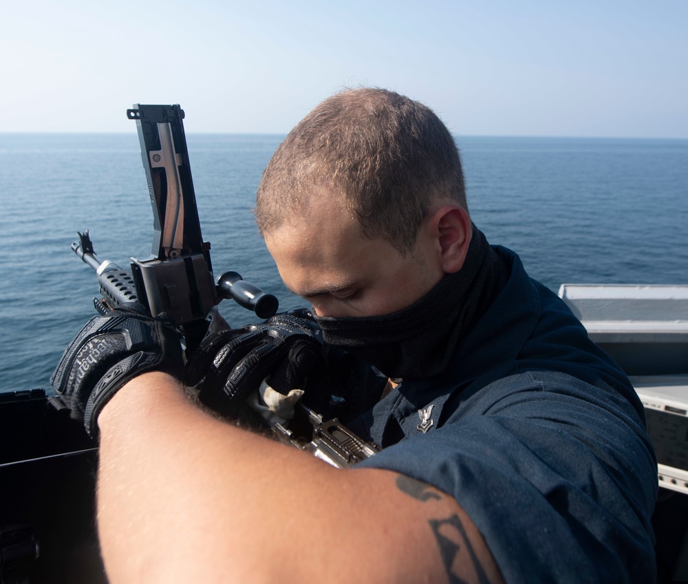 Ralph Johnson Sailor conducts gun maintenance