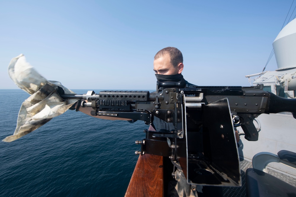 Ralph Johnson Sailor conducts gun maintenance