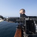 Ralph Johnson Sailor conducts gun maintenance