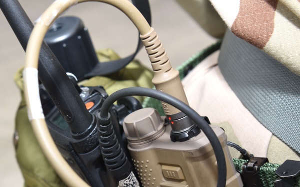 Maintainers, aircrew test in-ear headset during CBRN exercise