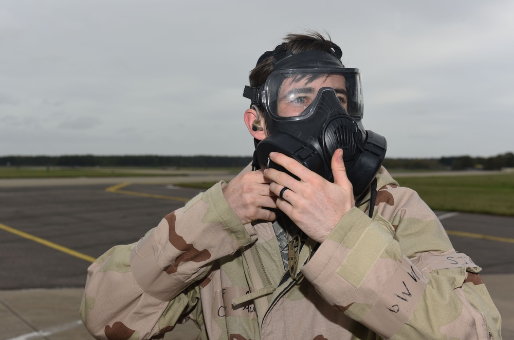 Maintainers, aircrew test in-ear headset during CBRN exercise