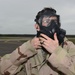 Maintainers, aircrew test in-ear headset during CBRN exercise