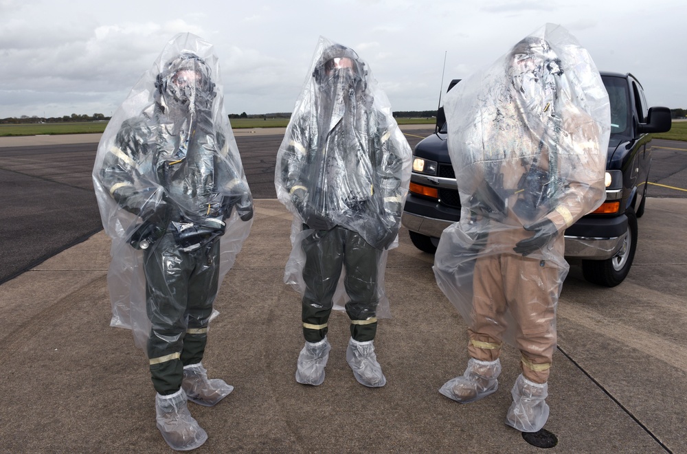 Maintainers, aircrew test in-ear headset during CBRN exercise