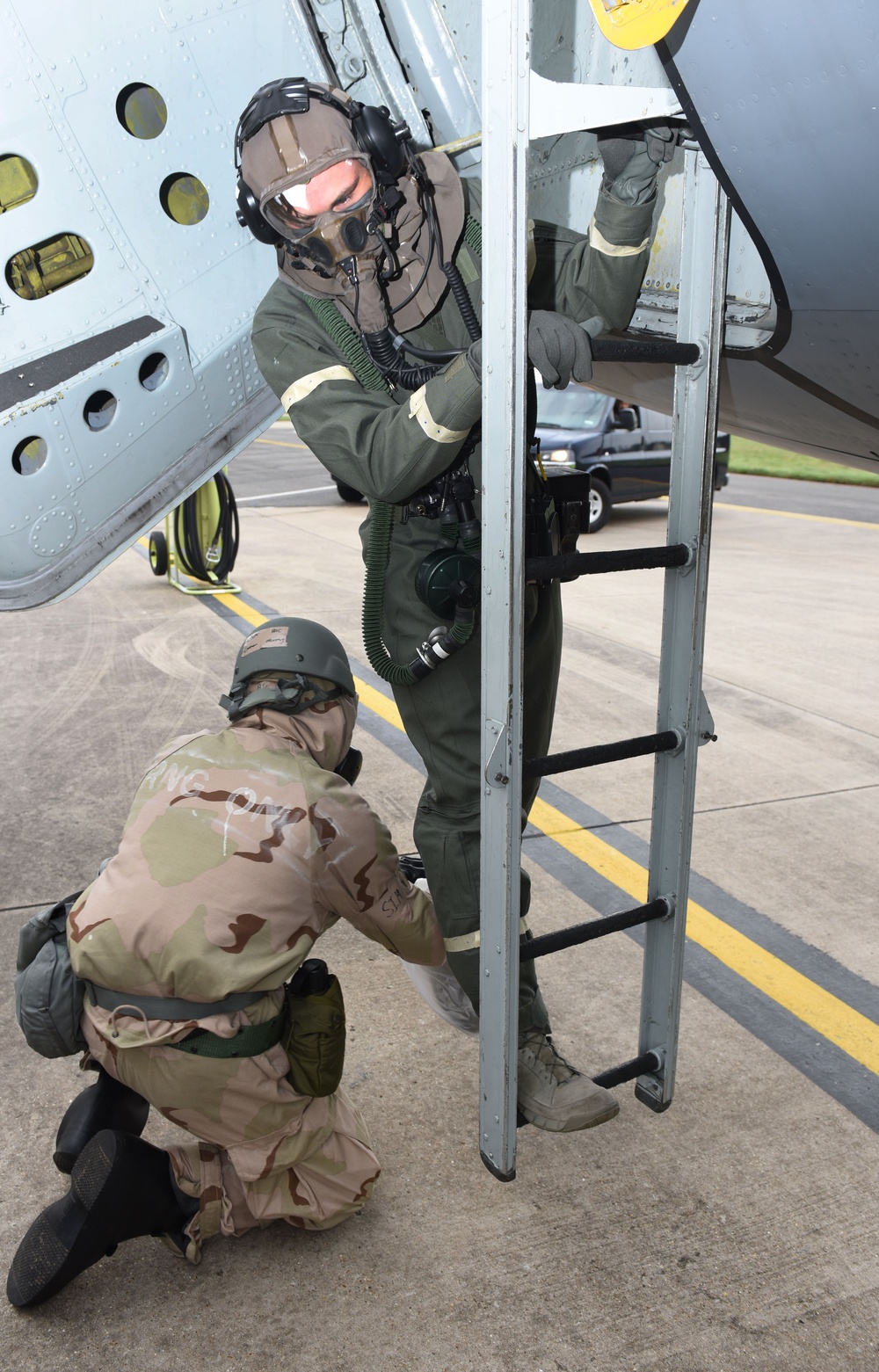 Maintainers, aircrew test in-ear headset during CBRN exercise