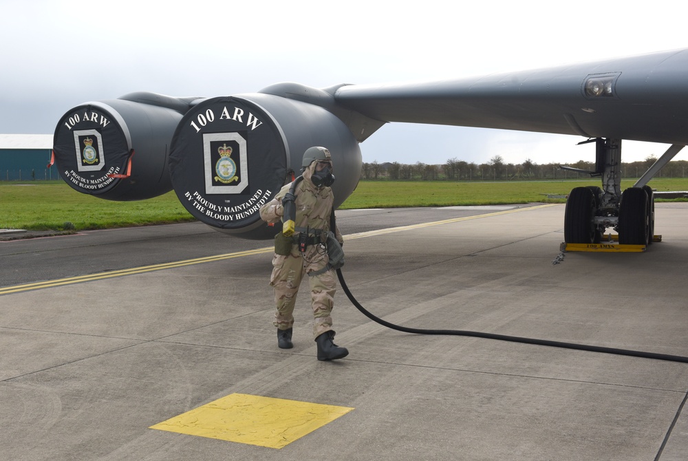 Maintainers, aircrew test in-ear headset during CBRN exercise