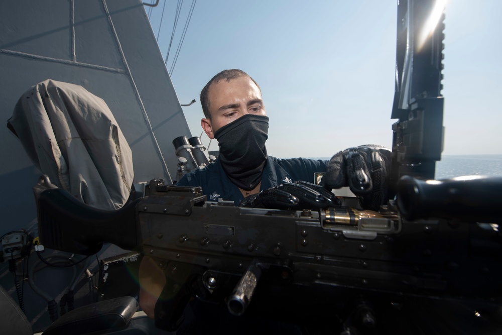 Ralph Johnson Sailor conducts gun maintenance