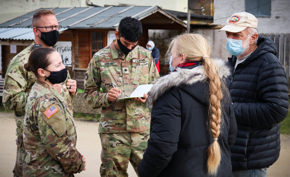 Iowa Soldiers interact with civilian role players at JMRC