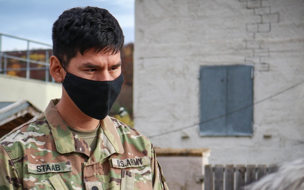 Iowa Soldier interacts with civilian role players at JMRC