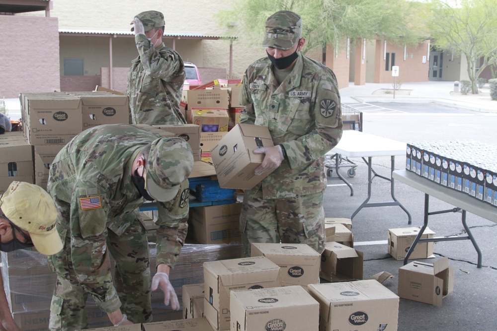 Arizona National Guard members load food into local residents vehicles from local food banks. Arizona National Guard members load food into local residents vehicles from local food banks.