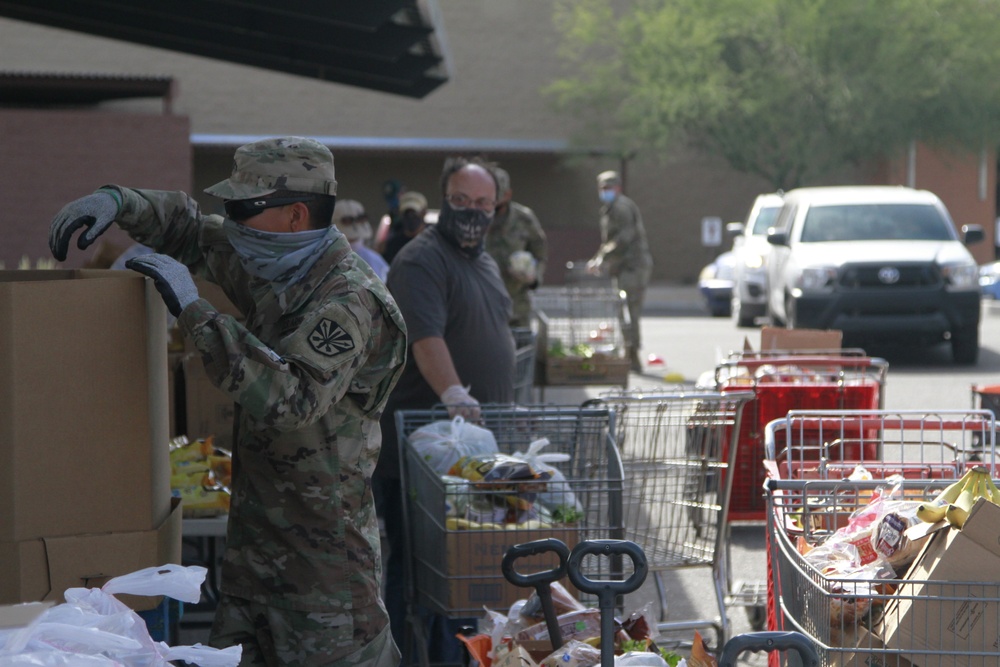 Arizona National Guard members load food into local residents vehicles from local food banks.
