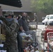 Arizona National Guard members load food into local residents vehicles from local food banks.
