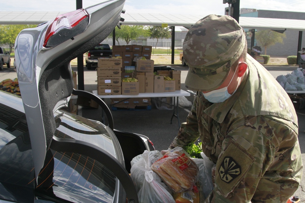 Arizona National Guard members load food into local residents vehicles from local food banks.