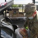 Arizona National Guard members load food into local residents vehicles from local food banks.