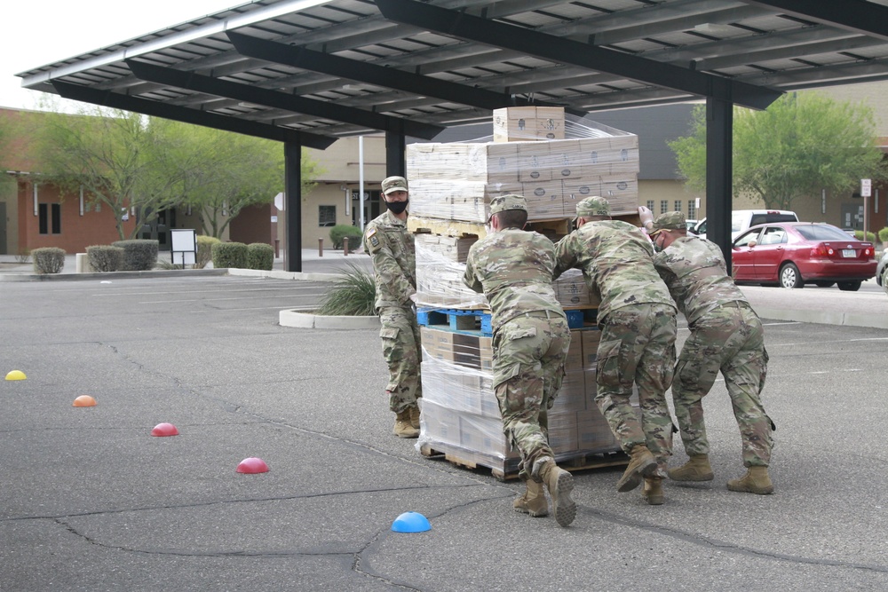 Arizona National Guard members load food into local residents vehicles from local food banks.