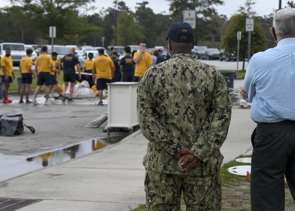 CAPT Ewing and CMC McDermott watch as Sailors receive DECON Training