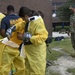 CAPT Ewing and CMC McDermott watch as Sailors receive DECON Training