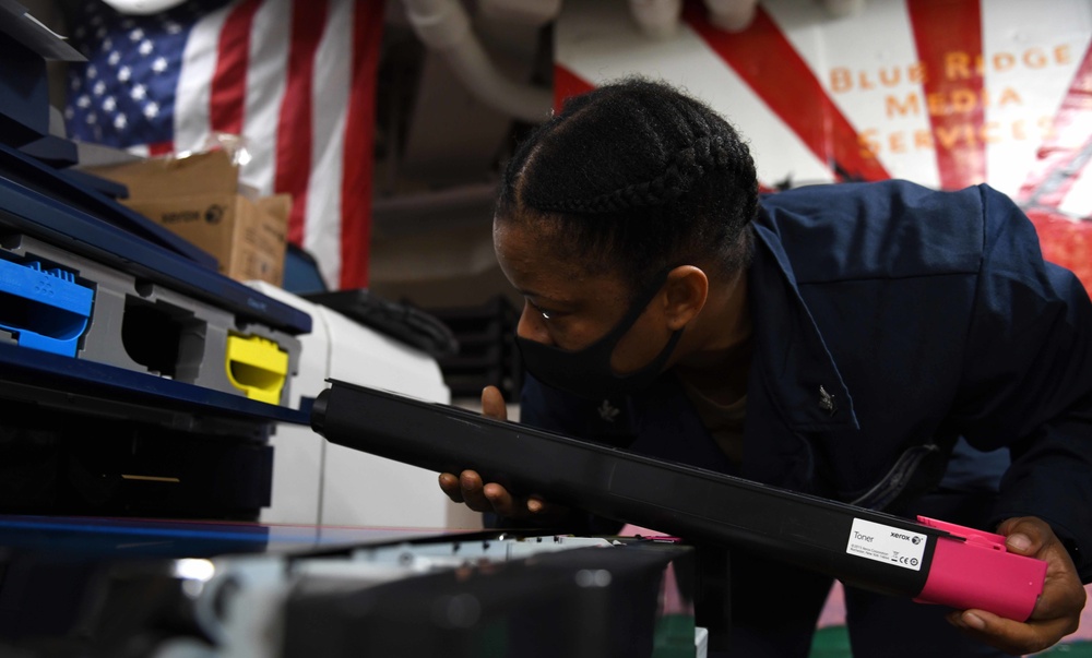 Electronics Technician Conducts Printer Maintenance