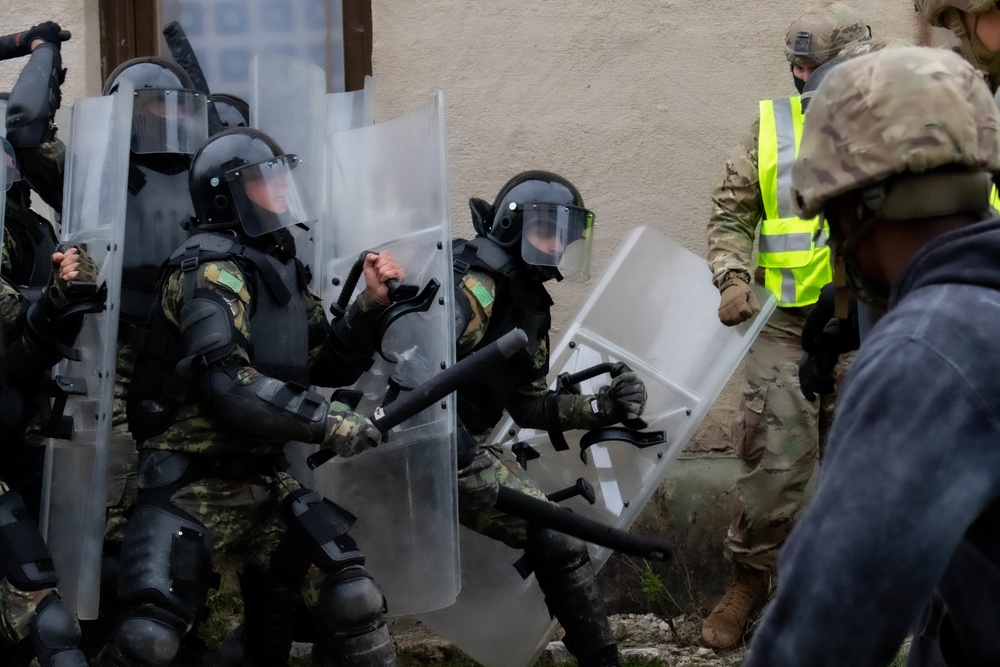 Riot control team pushes protesters back