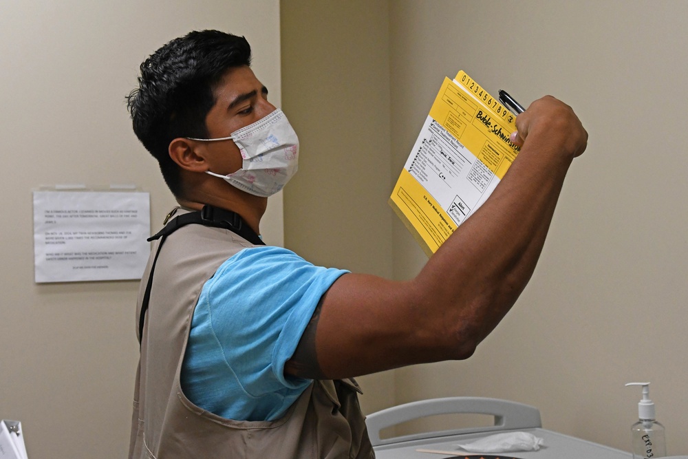 Sailor observes and records patient safety errors in the 'Room of Errors' at Branch Health Clinic (BHC) Kaneohe Bay