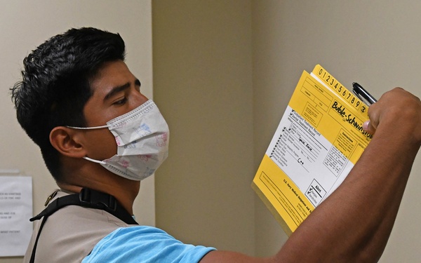 Sailor observes and records patient safety errors in the 'Room of Errors' at Branch Health Clinic (BHC) Kaneohe Bay