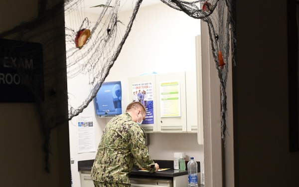 Sailor observes and records patient safety errors in the 'Room of Errors' at Branch Health Clinic (BHC) Makalapa