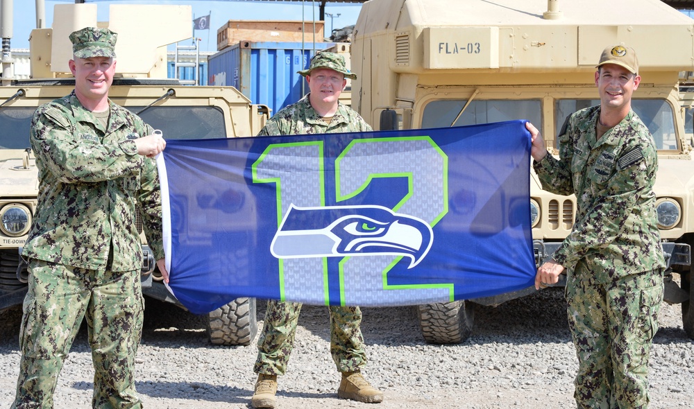 Seattle Seahawks Shoutout - U.S. Navy Lt. Cmdr. David Johnston, left, Cmdr. Kory Anglesey, center, and Cmdr. Schultz, right