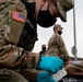 Soldier attends to simulated patient