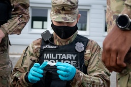 Soldier attends to simulated patient