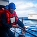 Sailor Heaves a Line During Replenishment-At-Sea