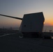 USS Ralph Johnson steams at sunset