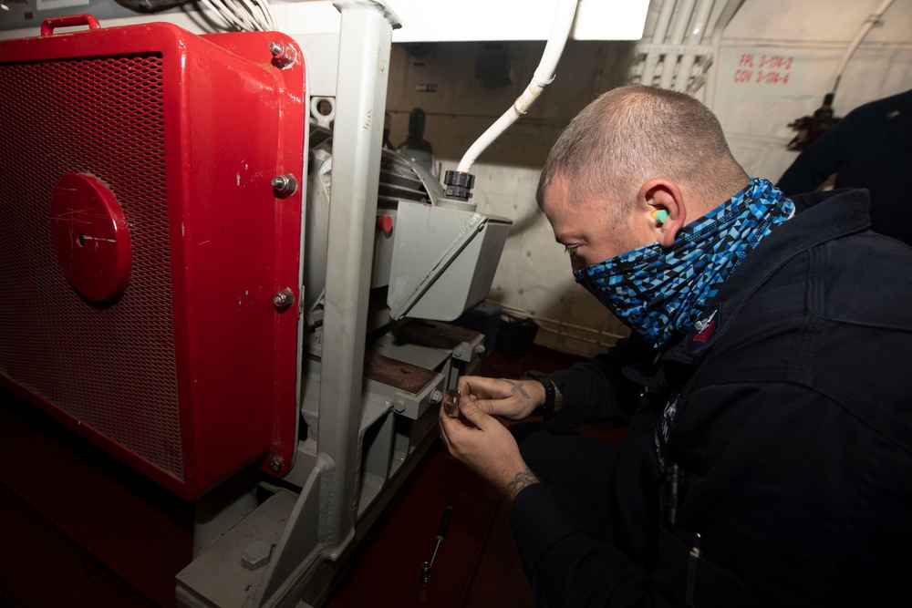 Sailor conducts maintenance on USS Ralph Johnson