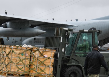 Sailors Load Cargo onto C-130