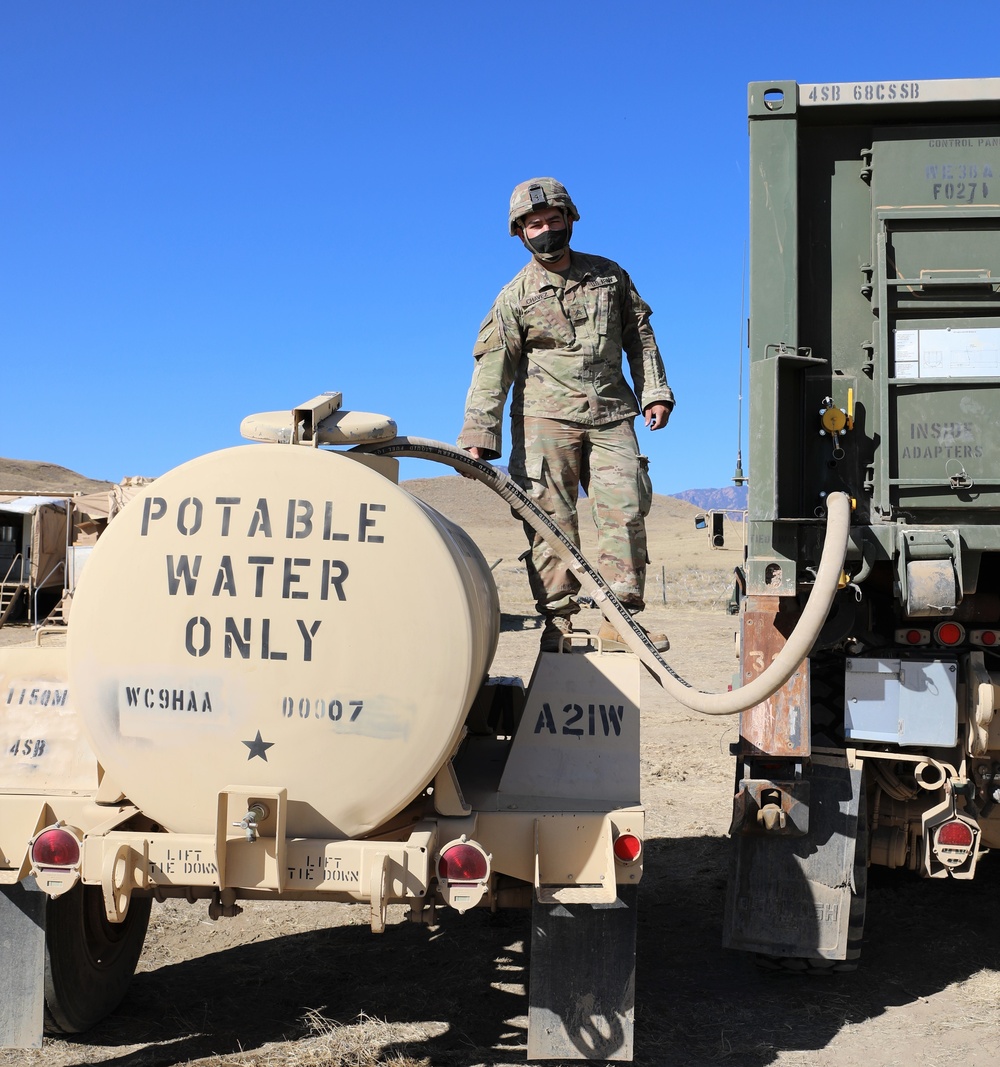 4th Infantry Division refills a 400-gallon water trailer